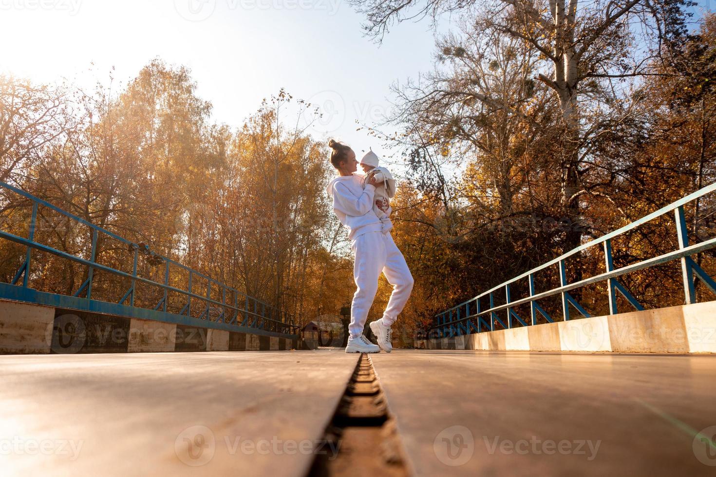 beautiful young mom with baby in autumn photo