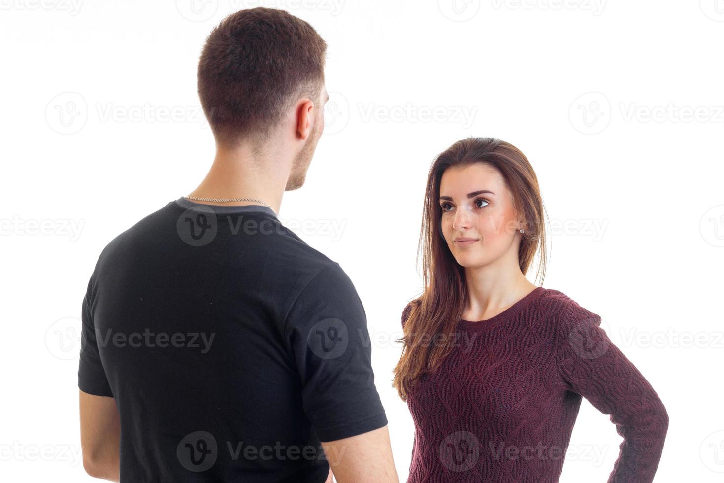 tall young guy in a black t-shirt stands opposite the girl and looks at her photo