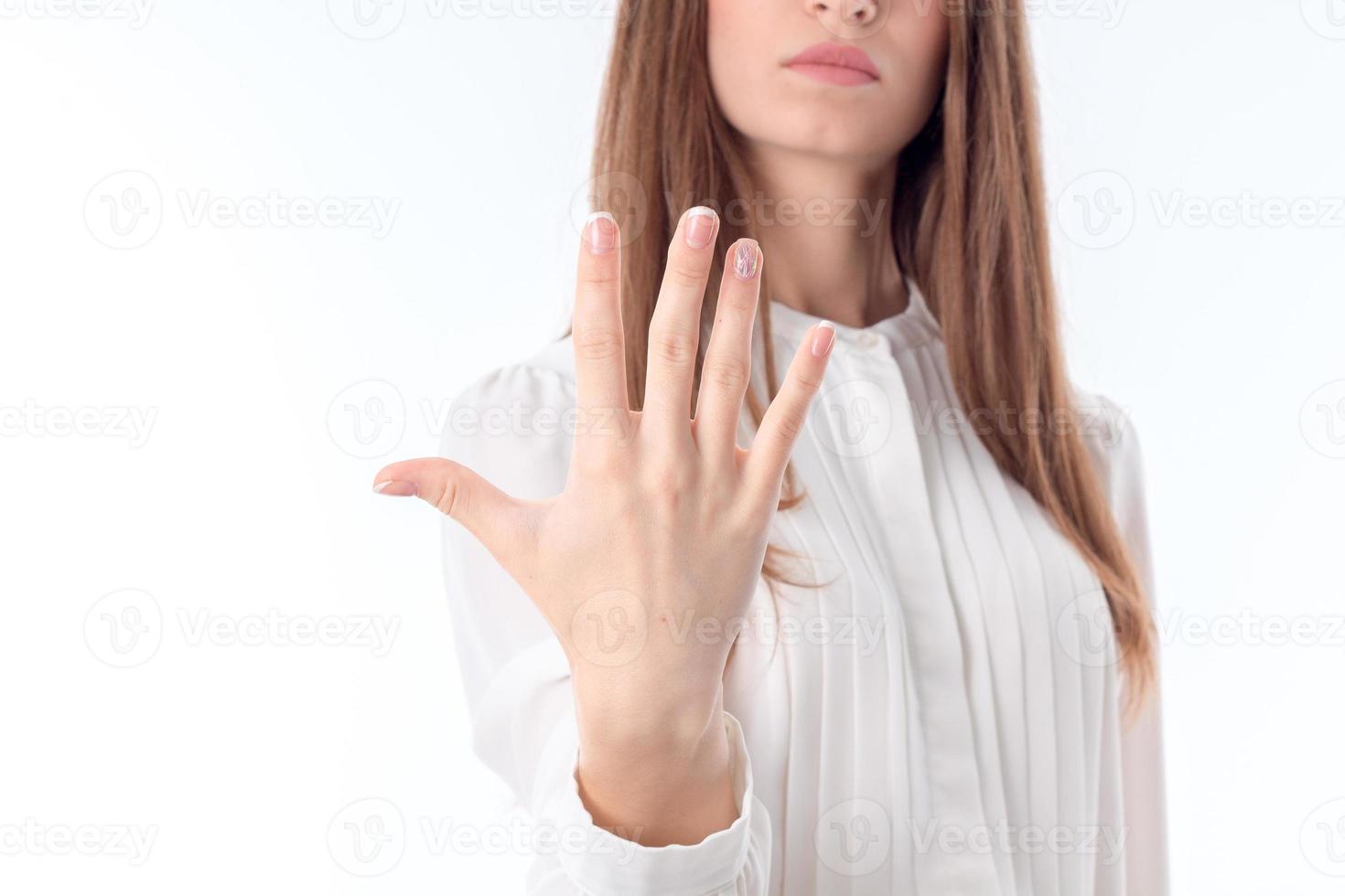 girl in white shirt holding a hand in front of you and shows five toes closeup photo