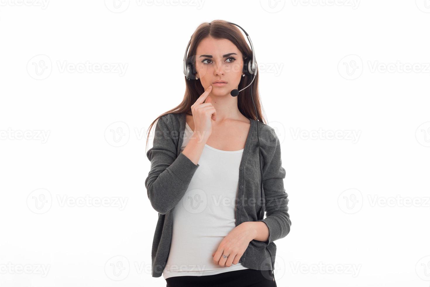 brooding young girl looks toward standing with headphones photo