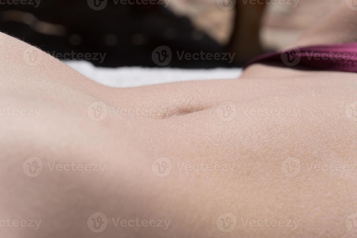 female sexy slim belly sunbathing photo