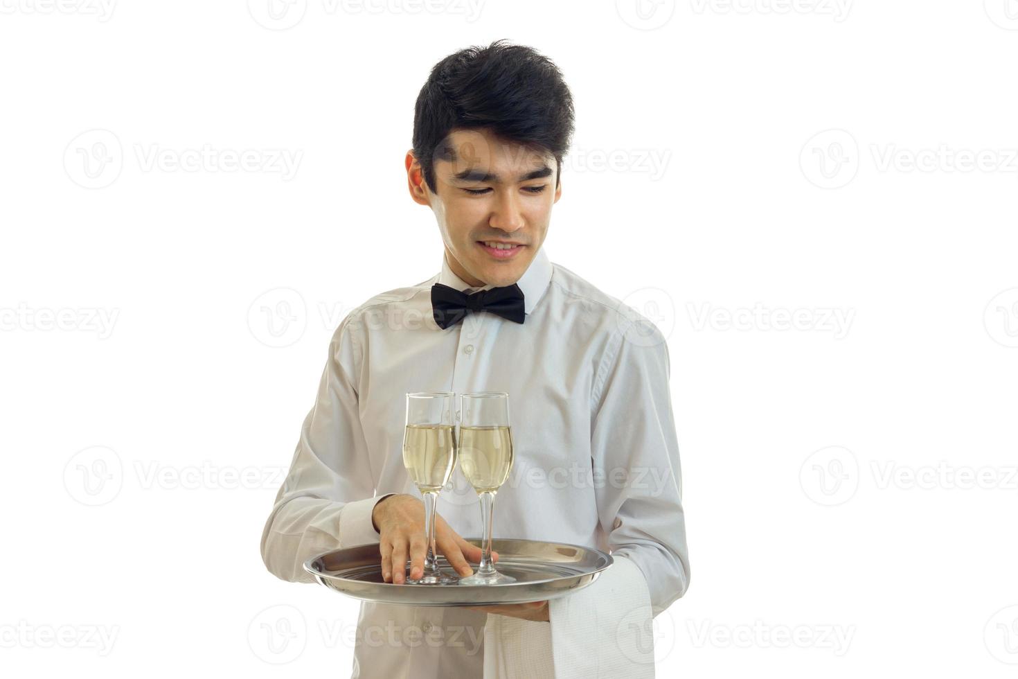 young brunette man waiter with champagne on tray smiling photo