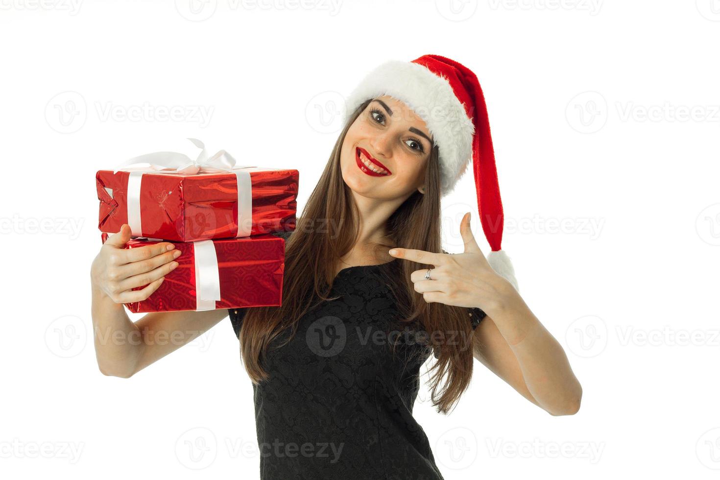 Cheerful Woman in santa hat with red gift photo