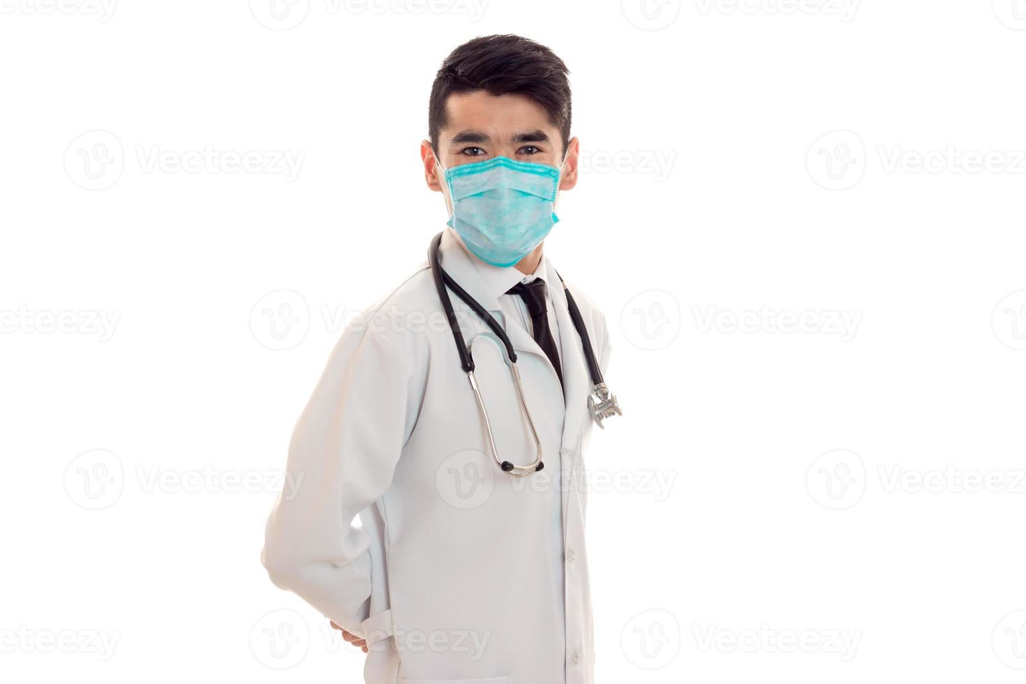 young elegant brunette doctor in uniform and mask with stethoscope isolated on white background photo