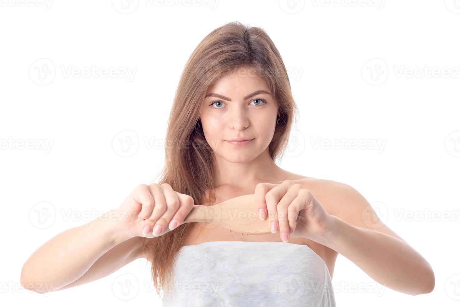 cute girl without makeup keeps before a comb is isolated on  white background photo