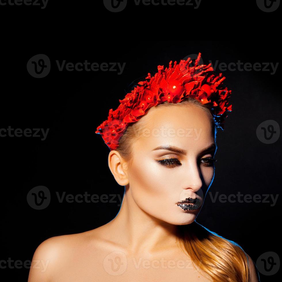 Square picture of beautiful woman with makeup and wreath on black background photo