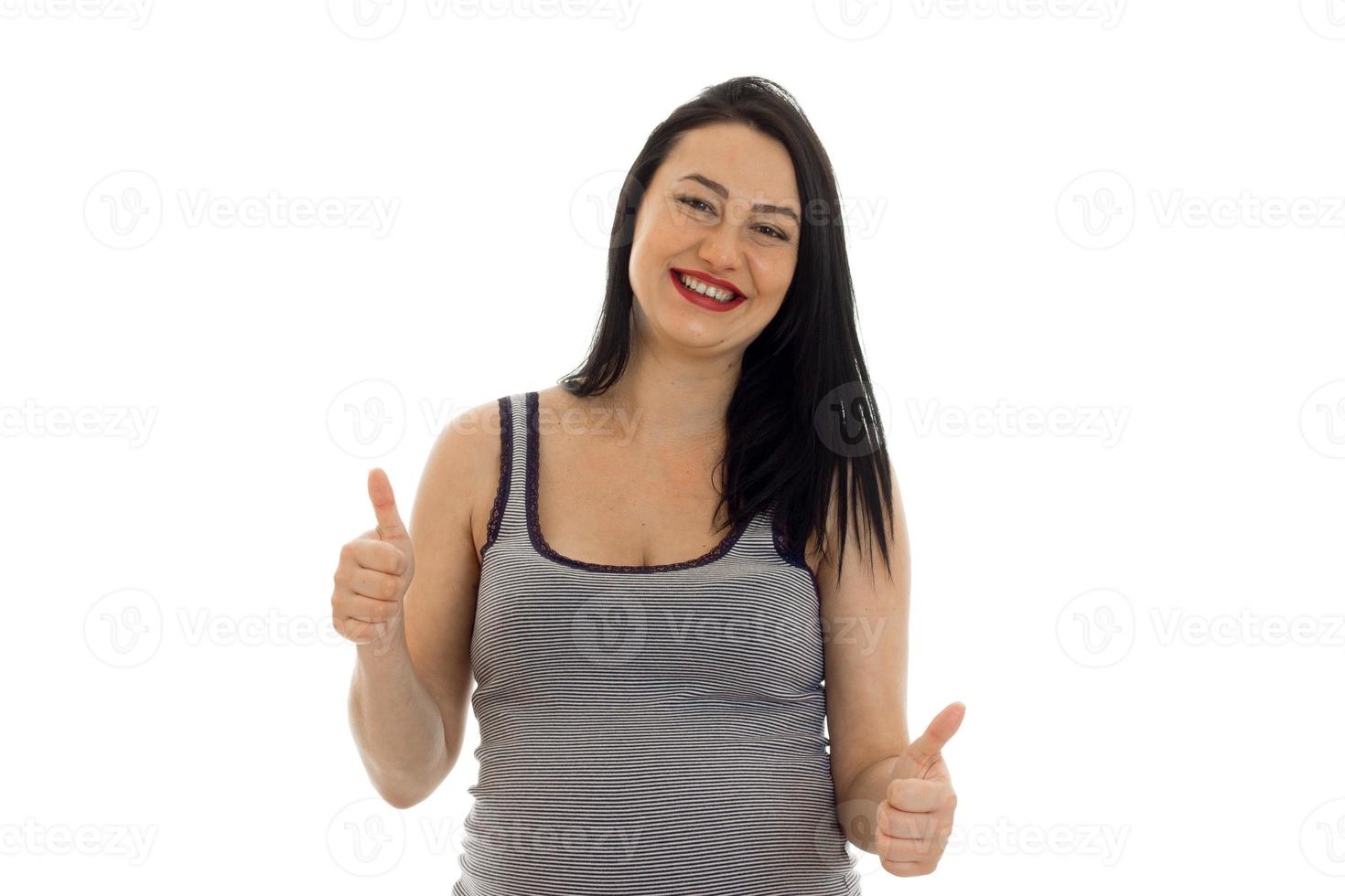 Young cheerful pregnant mother showing thumbs up isolated on white background in studio photo