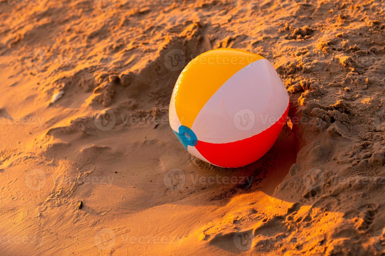 beach ball on the seashore at sunset photo