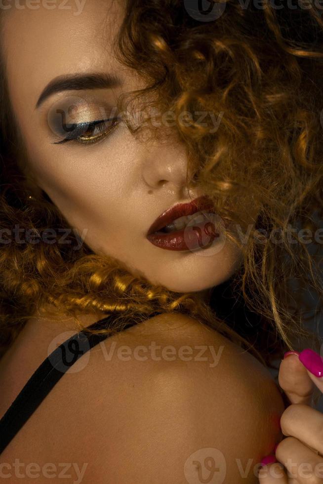 Close up potrait of beautiful lady with make up and curly hair photo
