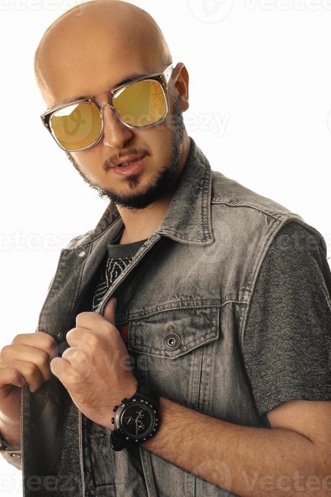Handsome unshaved man in sunglasses looking at the camera photo