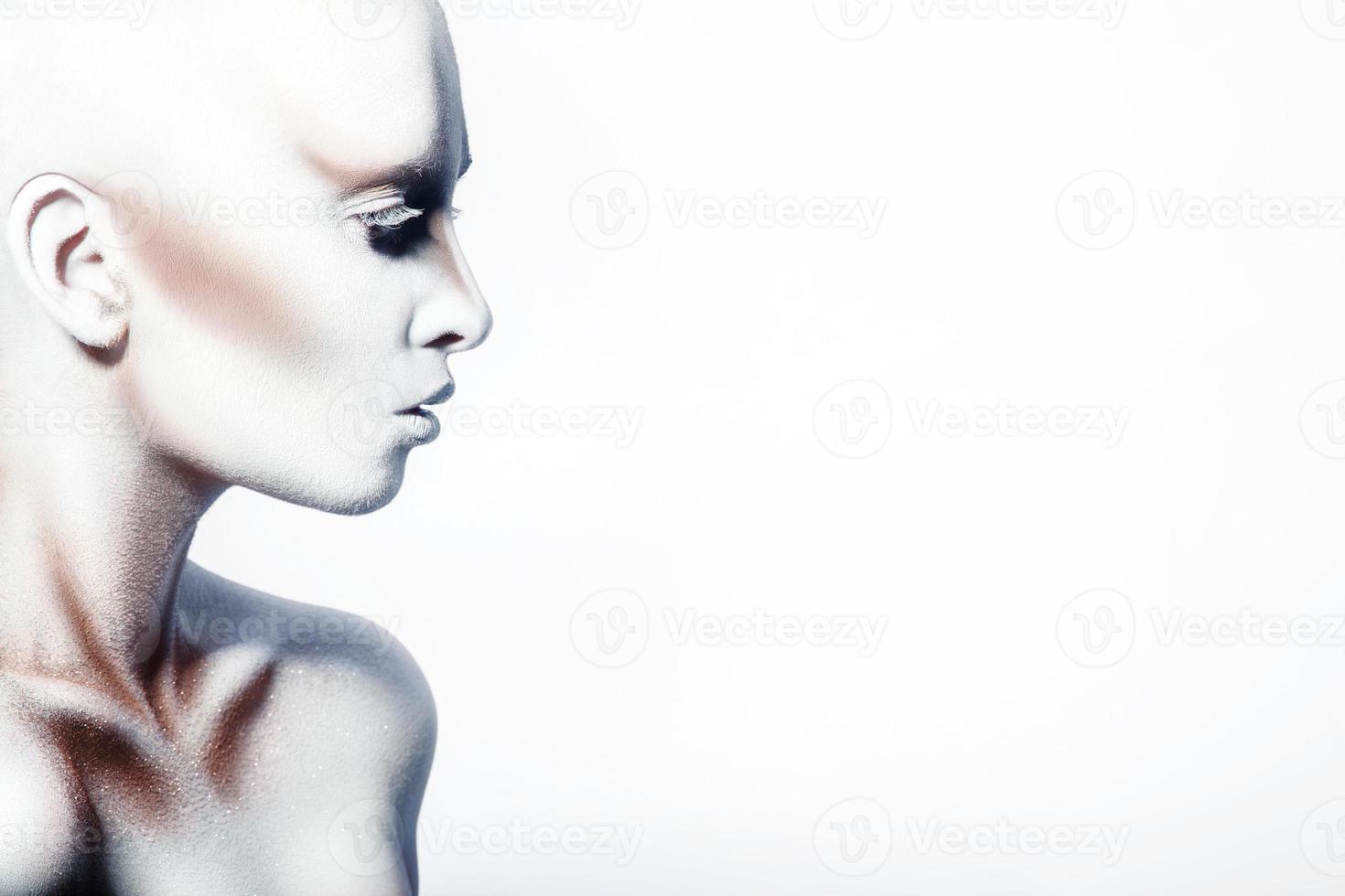 Beauty profile picture of female with white bodyart photo