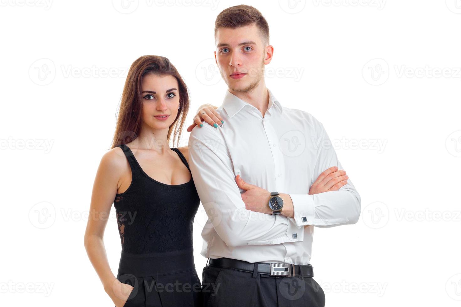 beautiful loving young couple standing next to each other and look forward isolated on a white background photo
