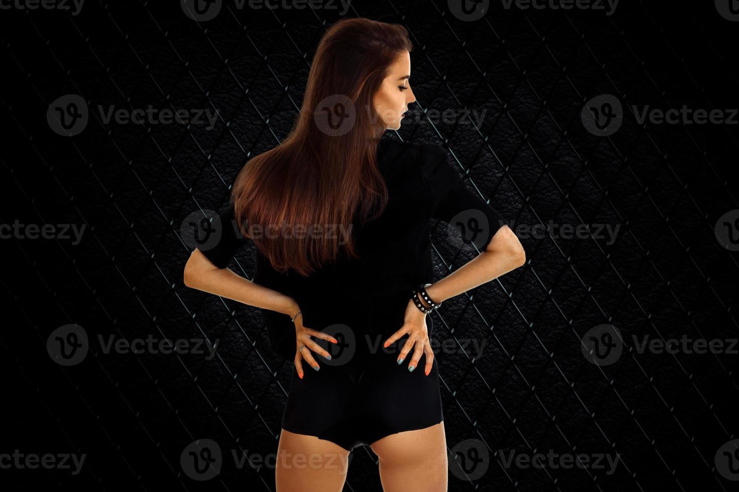 Sexy young brunette girl with beautiful round buttocks in studio photo