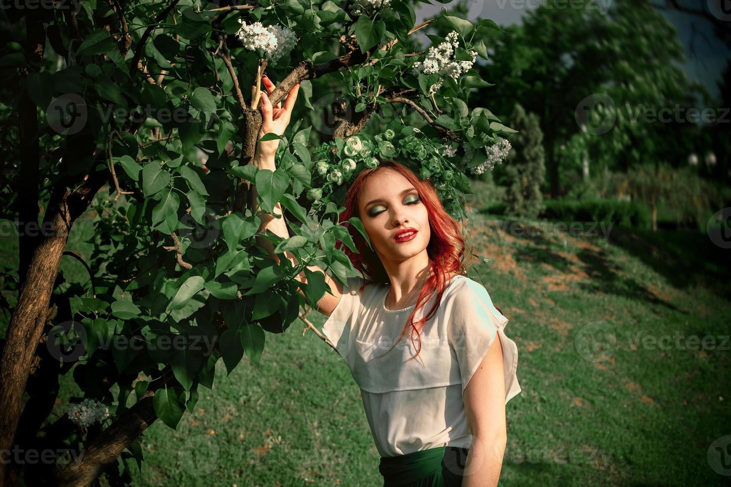 pretty young woman with makeup and wreath on head photo