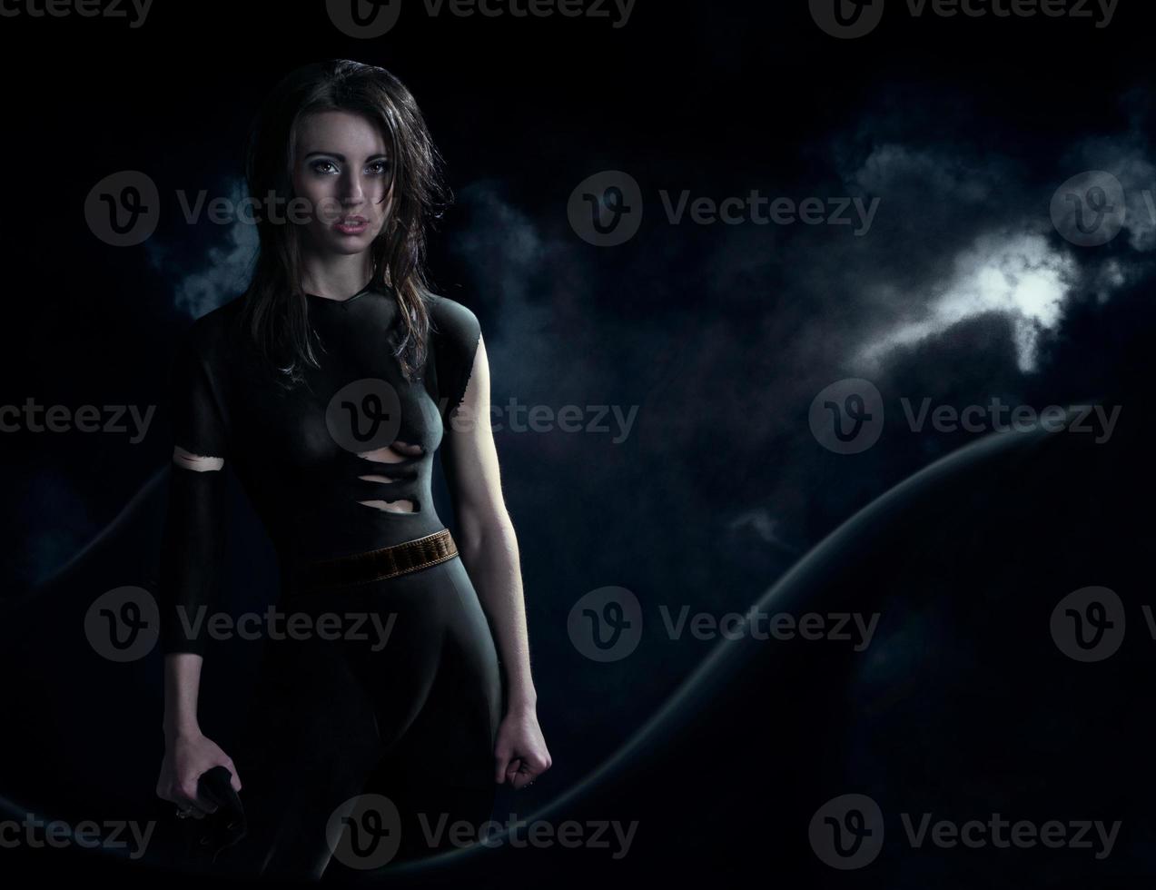 Superhero in dark suit and long cloak photo