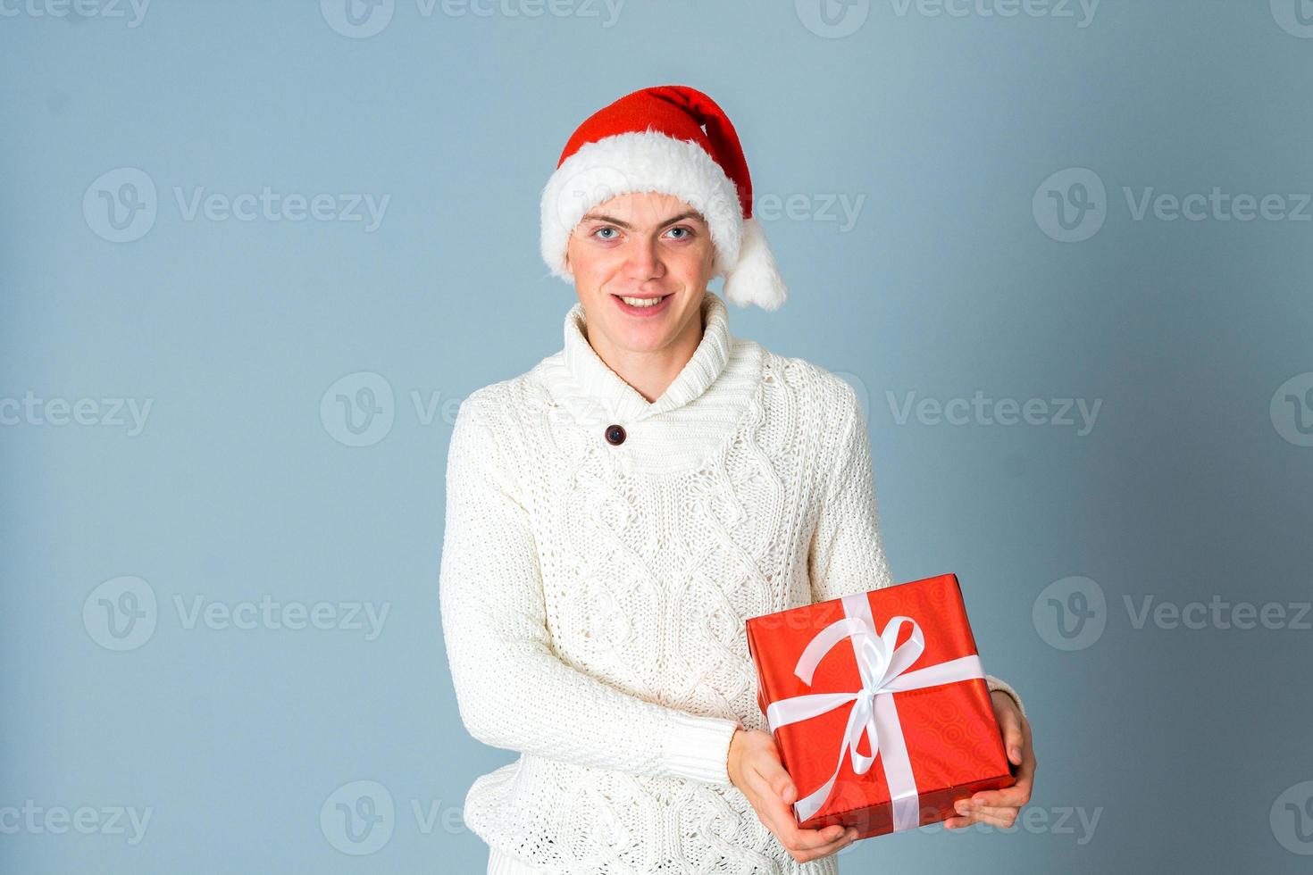 young man with gift box in hands photo