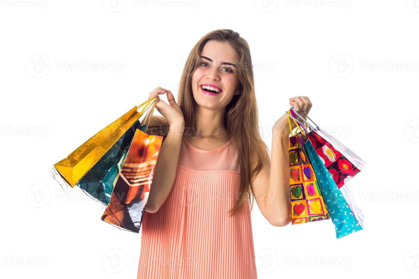 good beautiful girl keeps two hands many packages with gifts is isolated on a white background photo