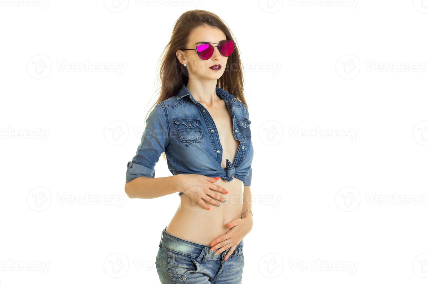 young beautiful slim girl in sunglasses and jeacns clothes photo