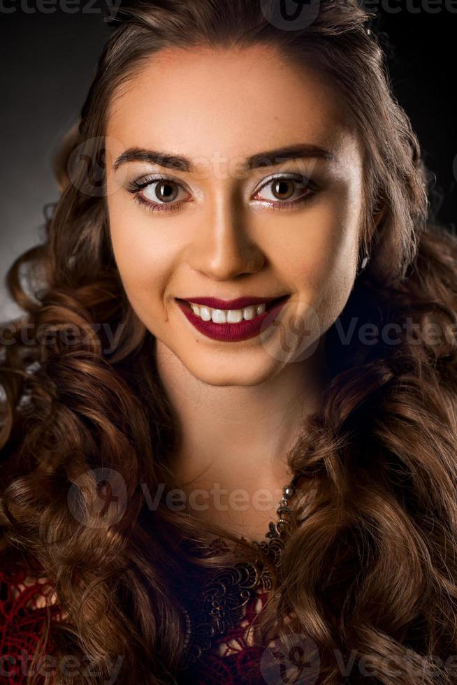 Charming young girl with beautiful curly hairstyle photo