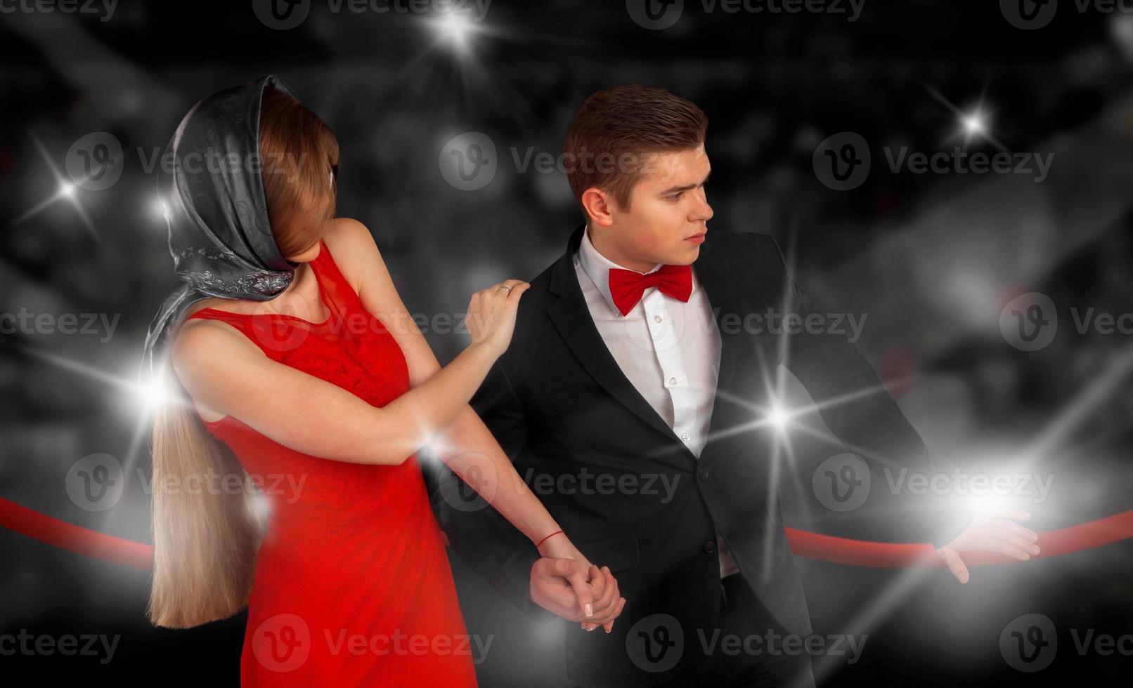 portrait of fashionable couple in paparazzi flashes photo