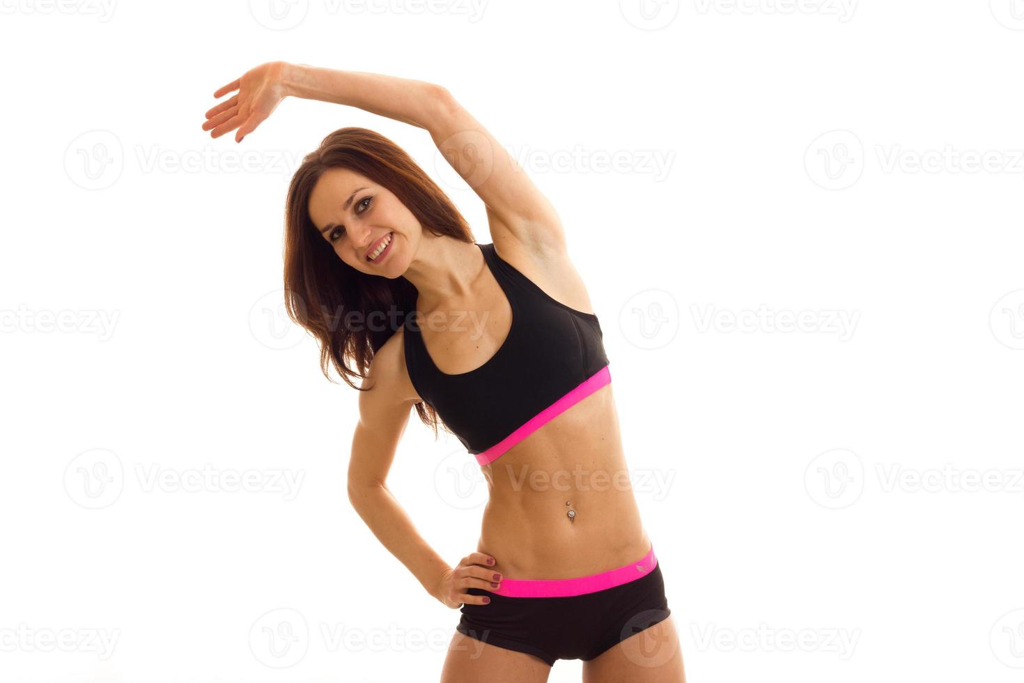 young brunette woman makes exercices and smiling photo