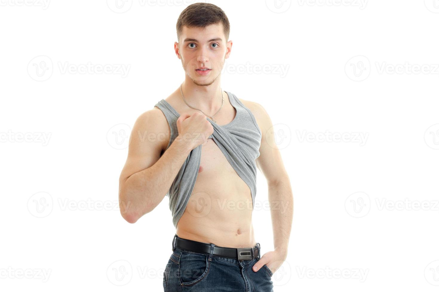 sporty young guy looking forward raises the hand Mike and shows body photo