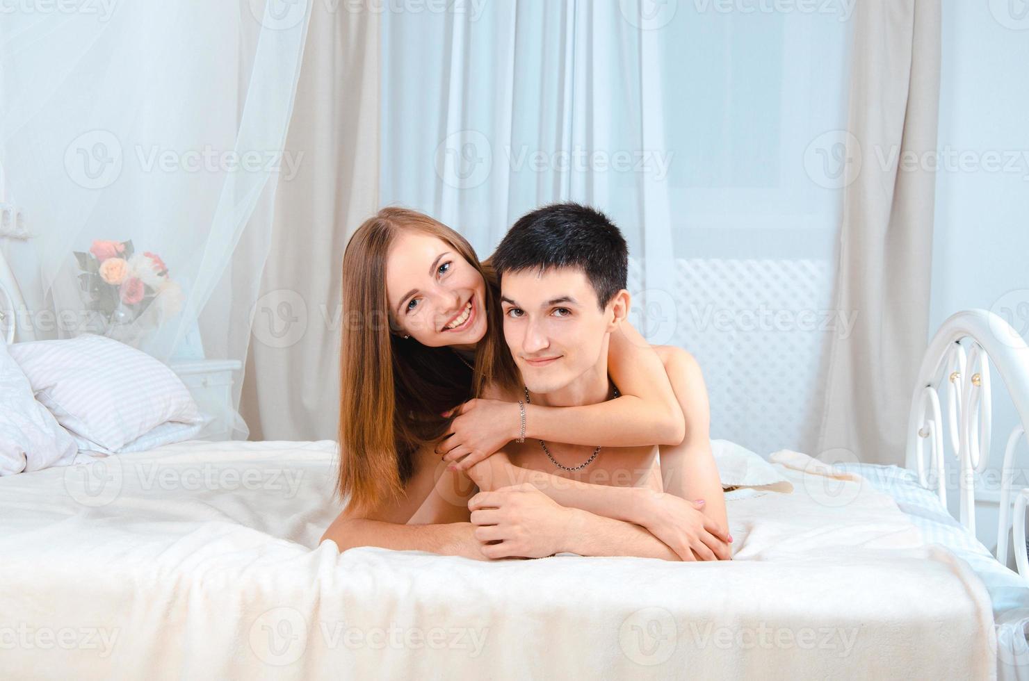 couple lovers lying in white bed photo