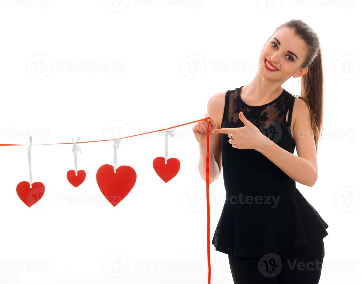 happy stylish brunette lady celebrate saint valentines day with red heart isolated on white background photo