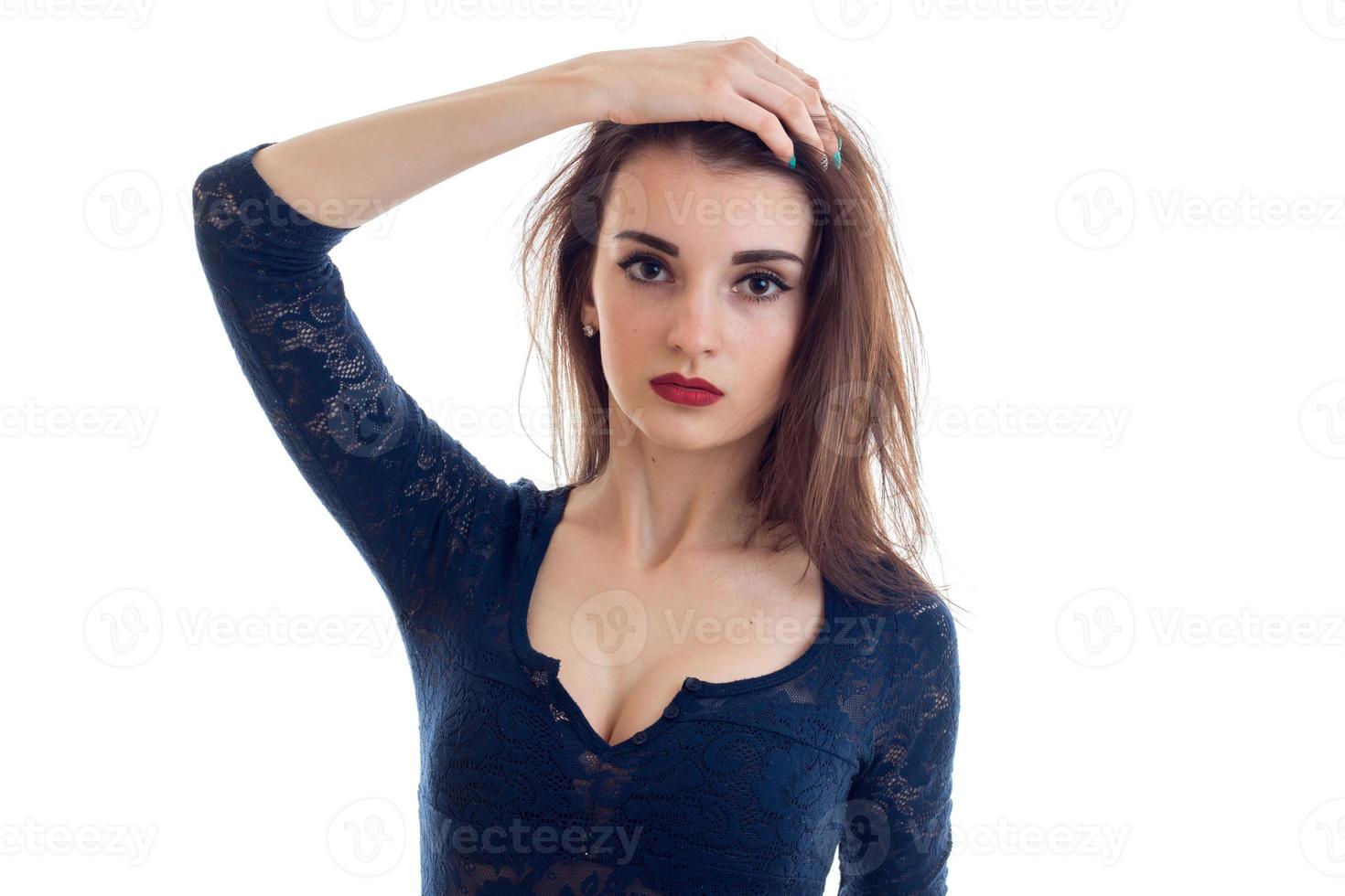 young beautiful girl with red lipstick on lips in a lace Bodysuit raised a hand to her hair and looks into a camera photo