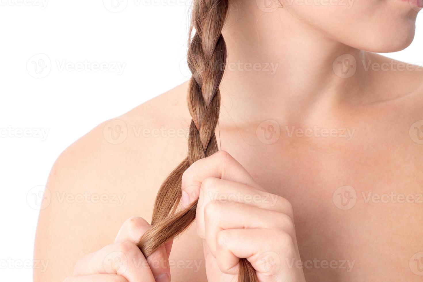 girl he plaits the braid with your hands close-up photo