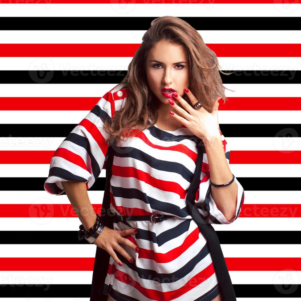 Nice brown hair girl on stripes background in studio photo