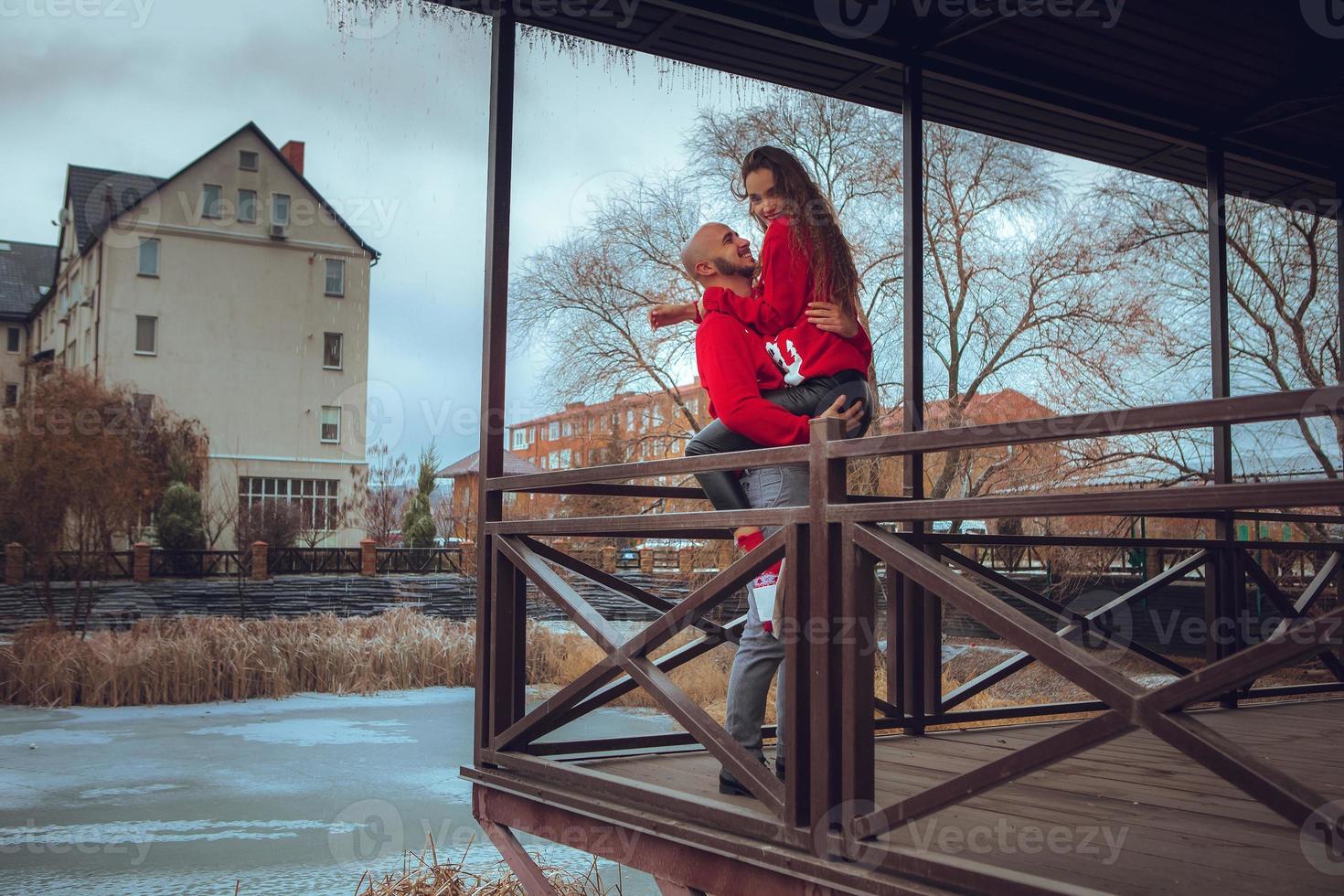 pretty couple hugs on a balcony winter time. Christmas Mood photo