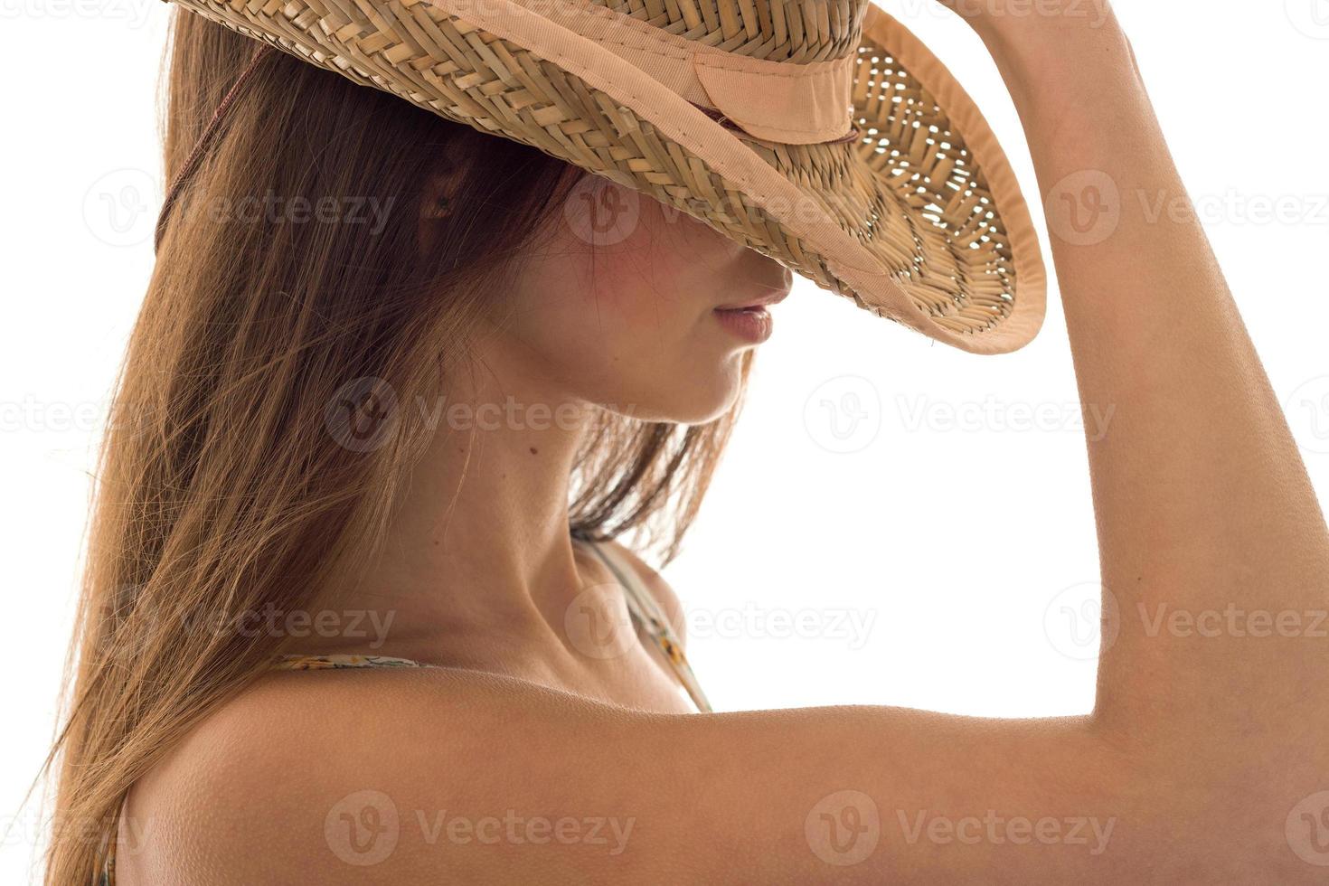young girl in straw hat with wide brim posing isolated on white background photo