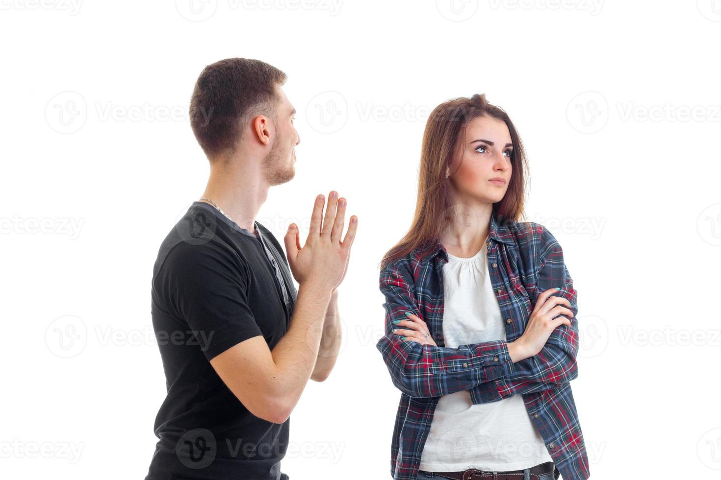 young guy asks forgiveness from girl and she turned away from him photo