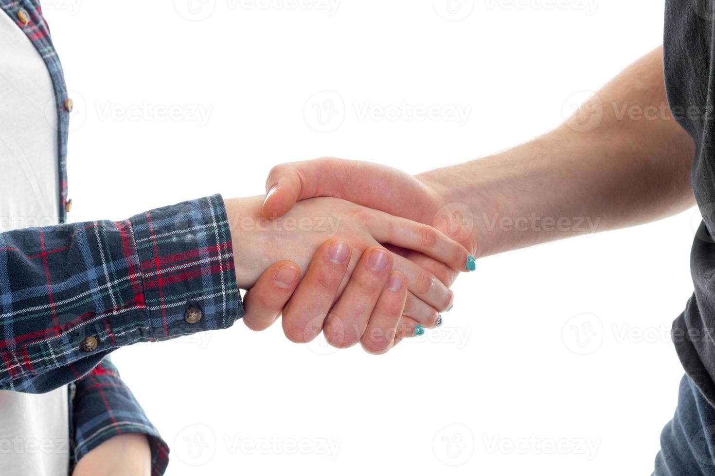 young guy shakes the hand of a girl close-up photo