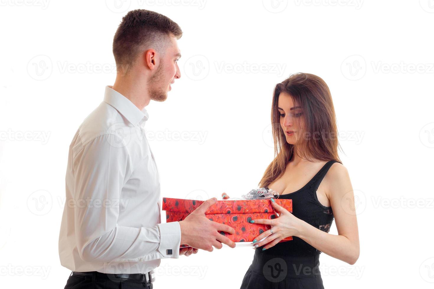 a young guy in a shirt brought the girl in red gift box close-up photo