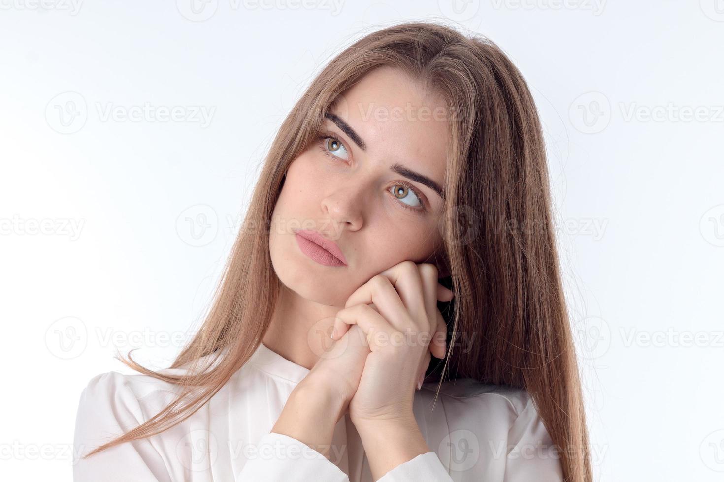 young girl looks away and keeps his hands face close-up photo