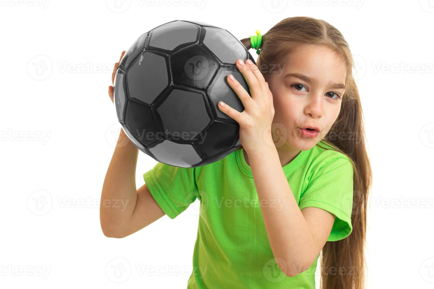 portrait of young girl with soccer ball in hands photo