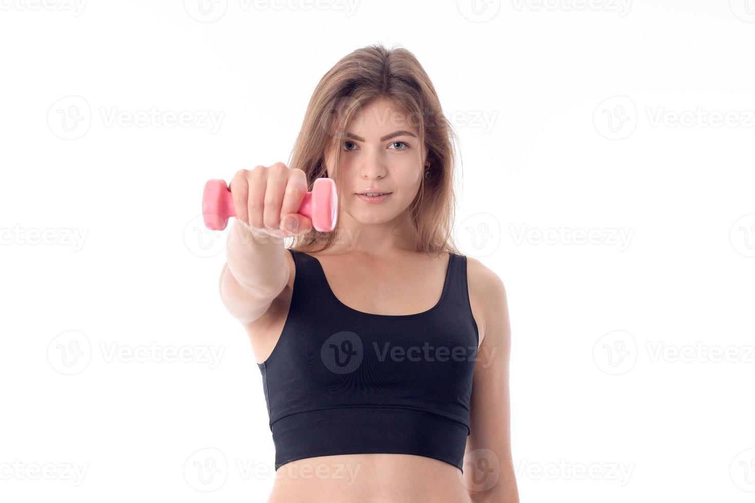 Beautiful young girl holding a dumbbell photo