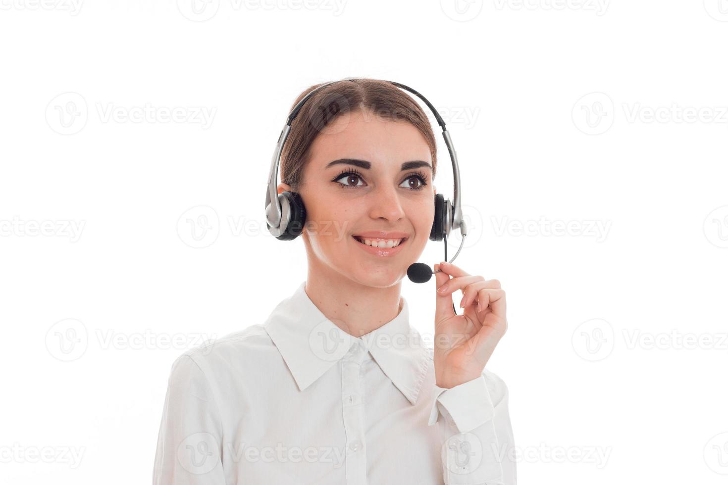 young girl in white shirt stands in headphones with microphone, smiling photo