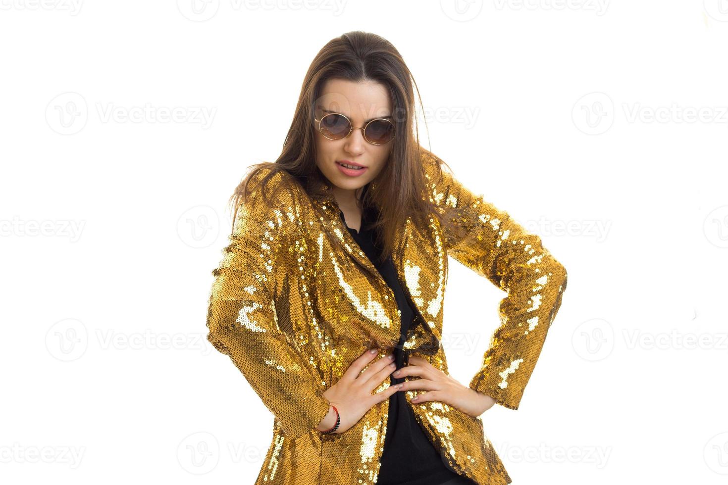 Beautiful woman in bright golden jacket looking at the camera photo