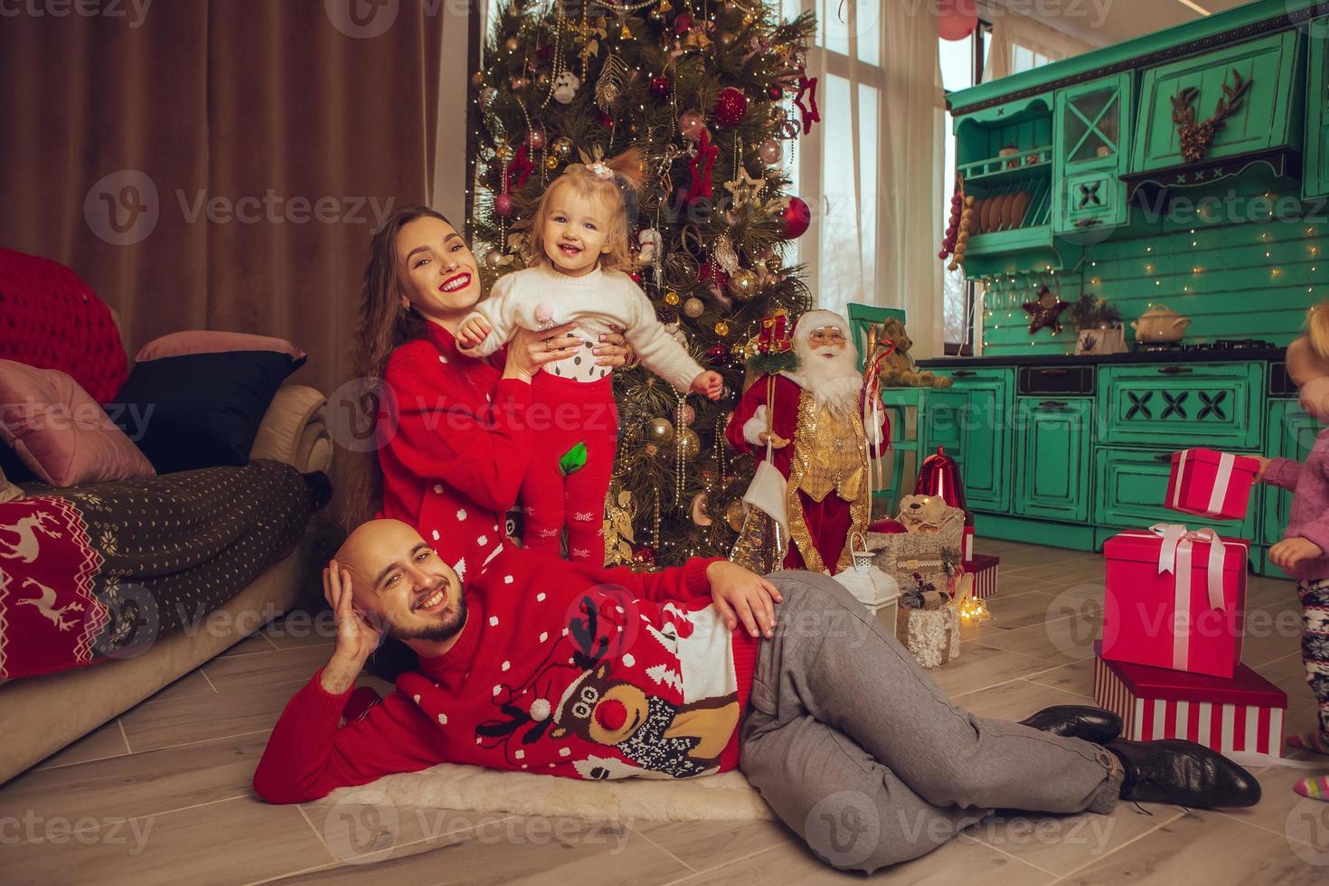 Cheerful family with daughter celebrate New year and Christmas photo