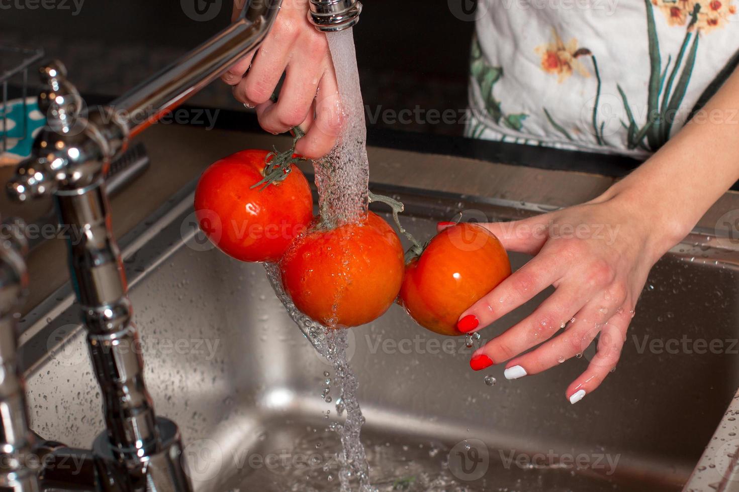 The girl is preparing vegetables for processing photo