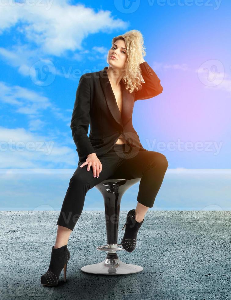 blonde with curly hair in black business suit photo