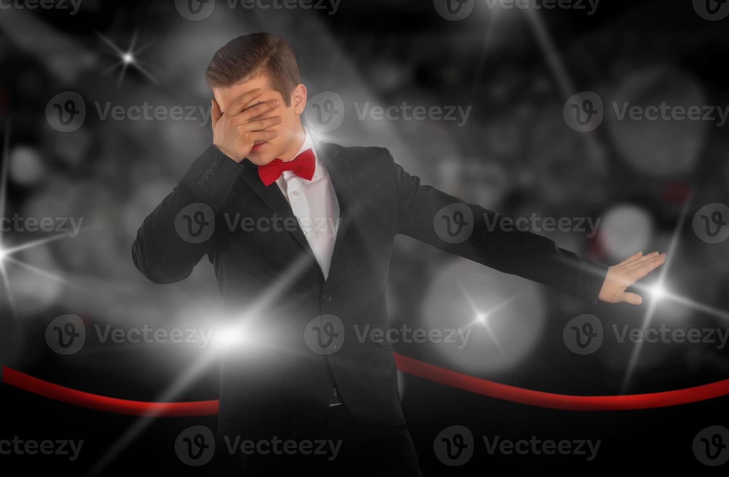 man in a suit is hiding from the paparazzi photo