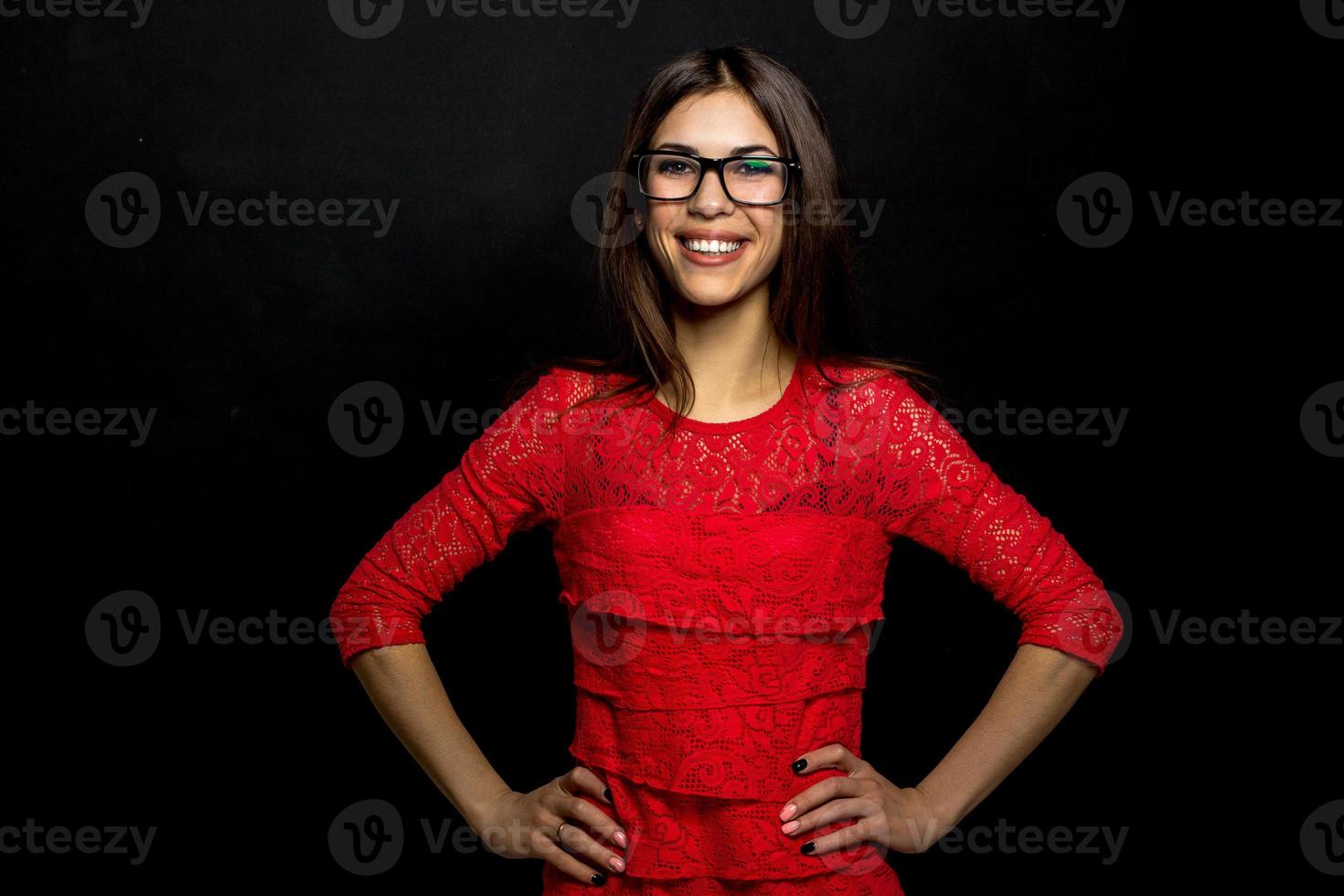 brunette in glasses smiling and looking at the camera photo