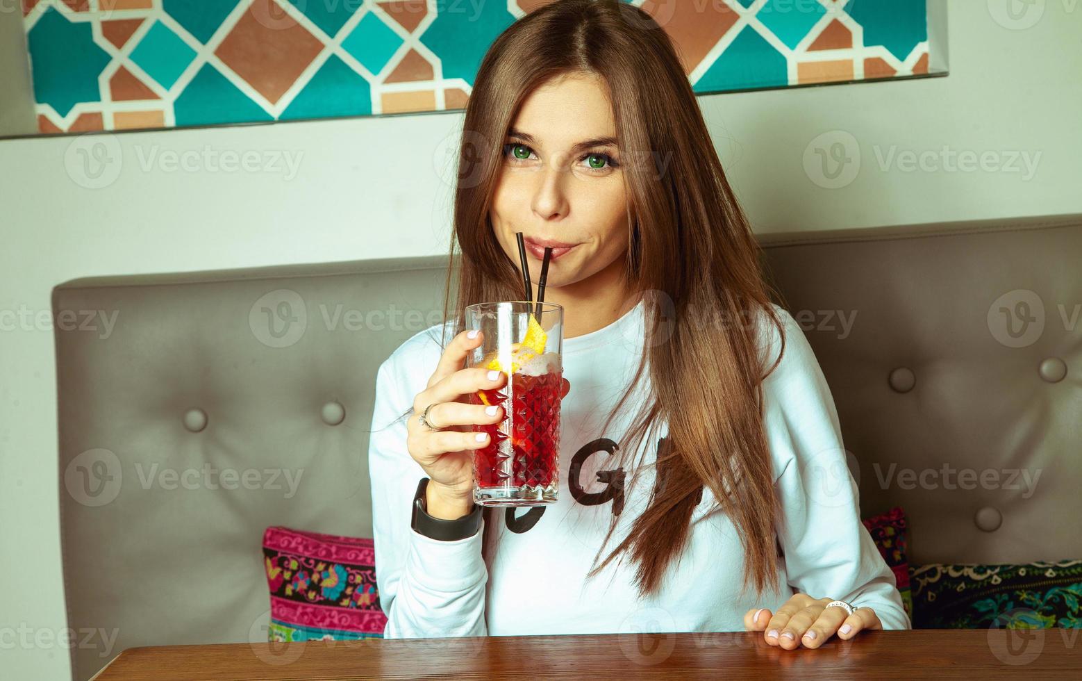 pretty brunette drinks cocktail photo