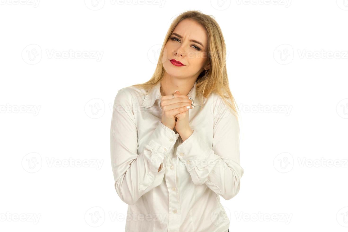 girl in a white shirt squeezes hands photo