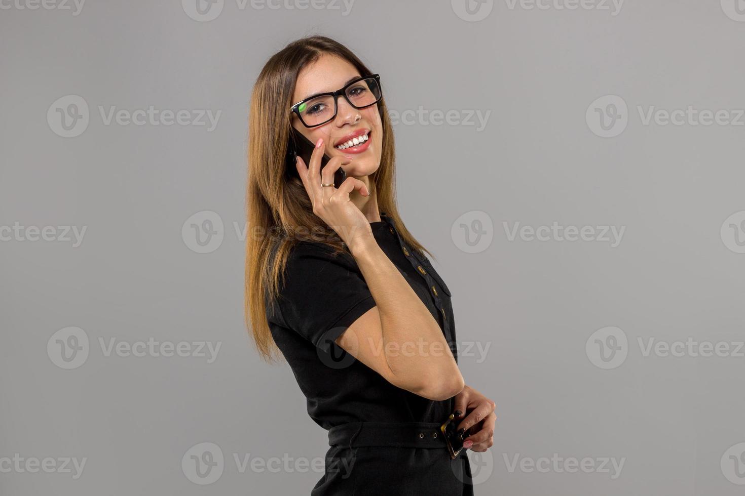 Girl in glasses talking phone photo
