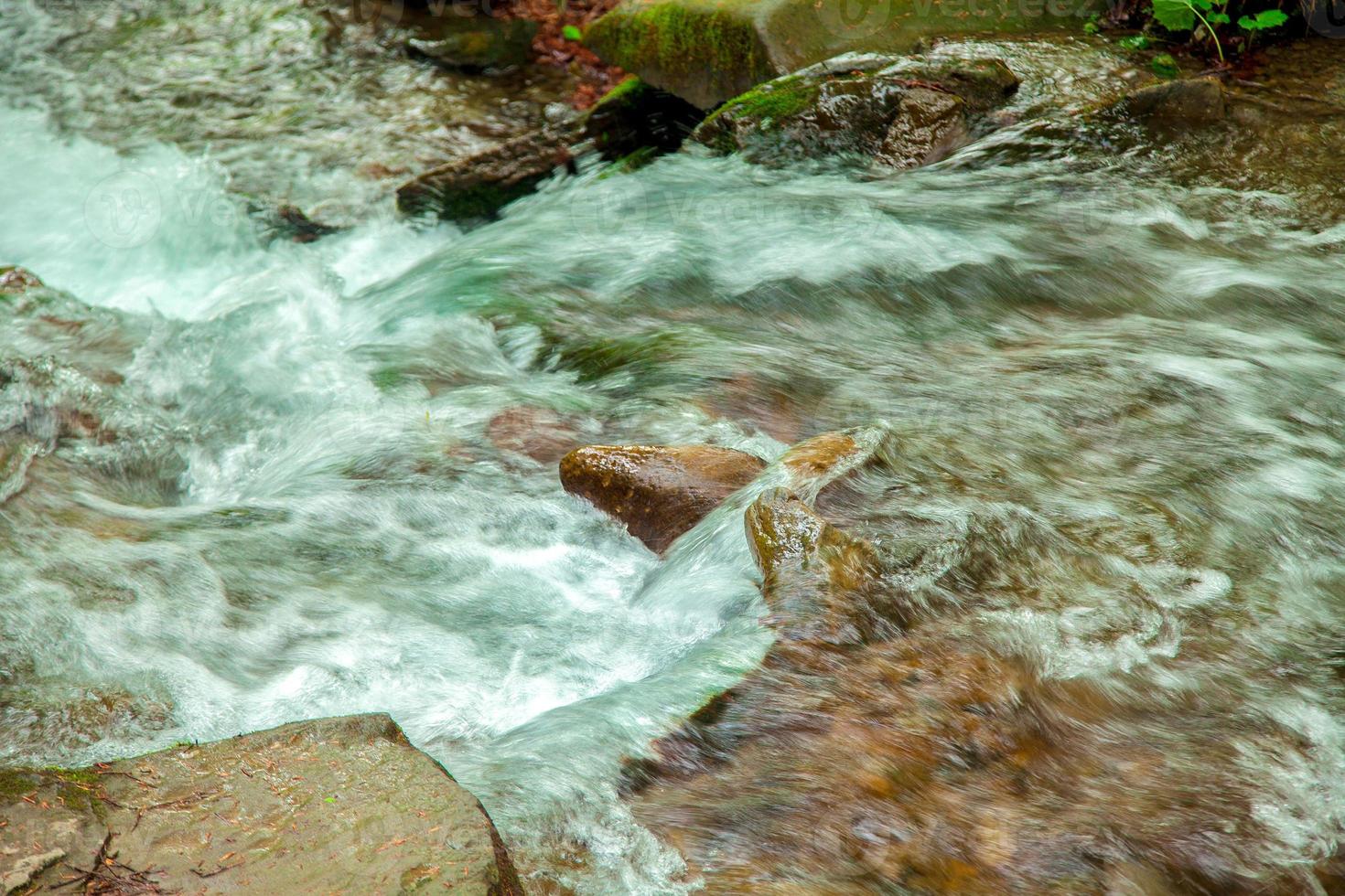 stormy river with rocky bottom photo